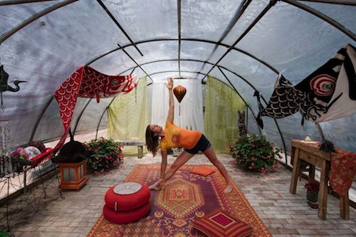 SoutholdLOCAL photo by Liz Glasgow. Bob Tapp, one of the show organizers, hoop house turned yoga studio. Pictured with Allegra Borghese of The Giving Room doing yoga. 
