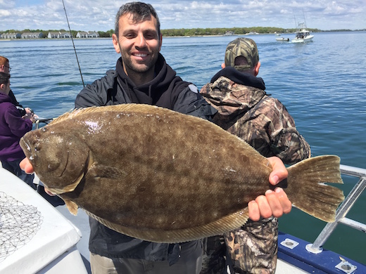 Frankie with a 7-pound fluke caught aboard the Orient Star IV 